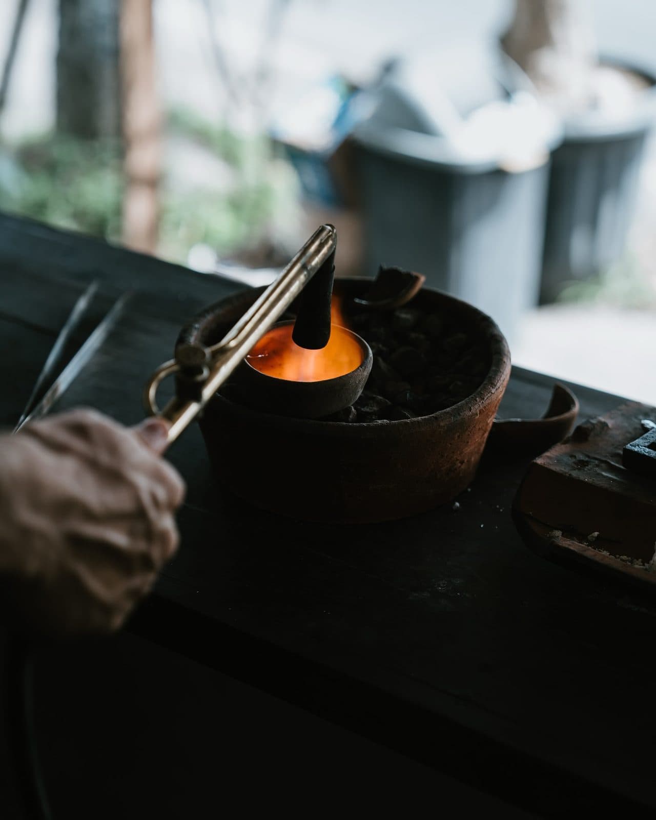 Metal glowing in a clay crucible under the torch
